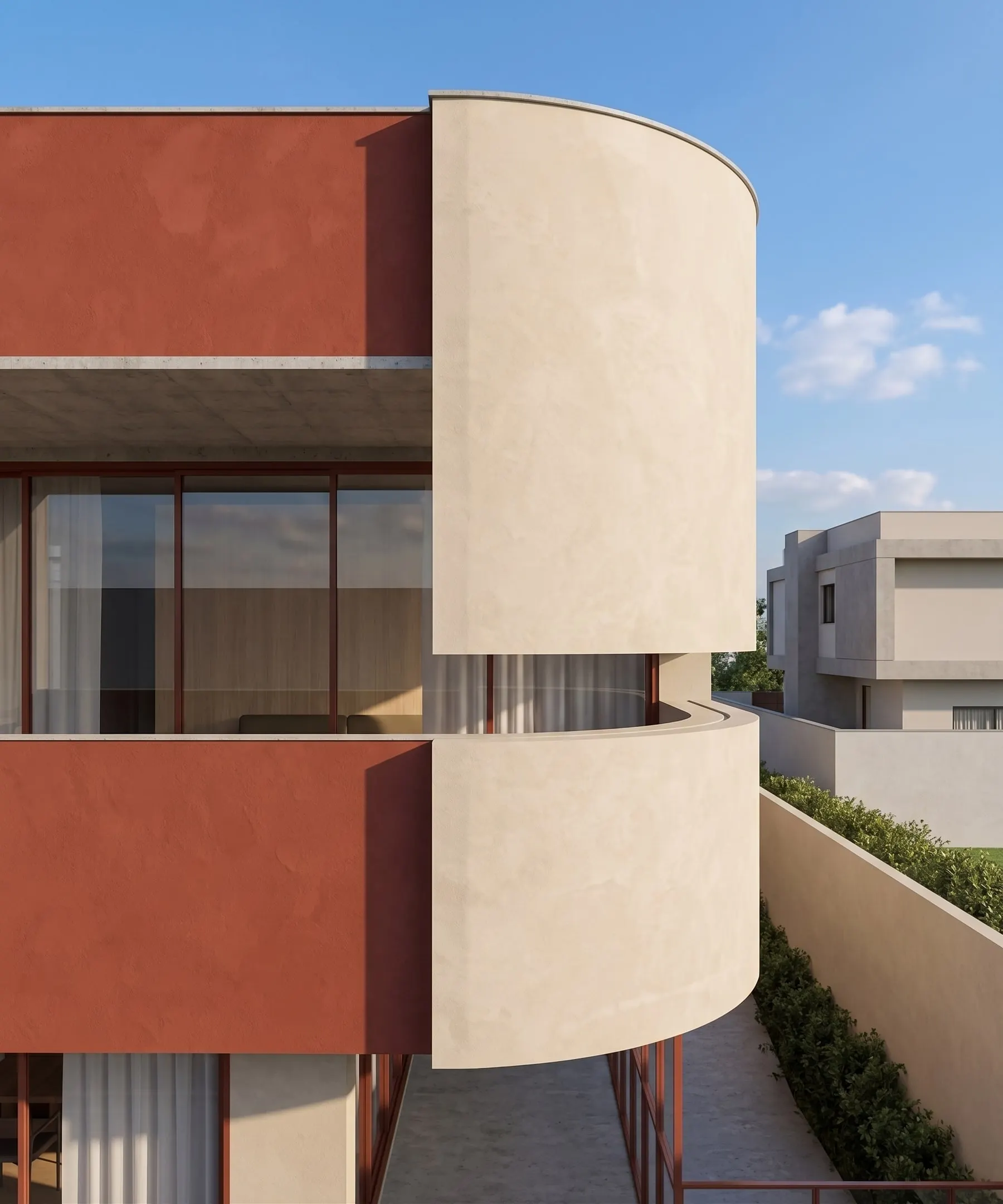 Detalhe do volume curvo em reboco areia sobre o vermelho terroso